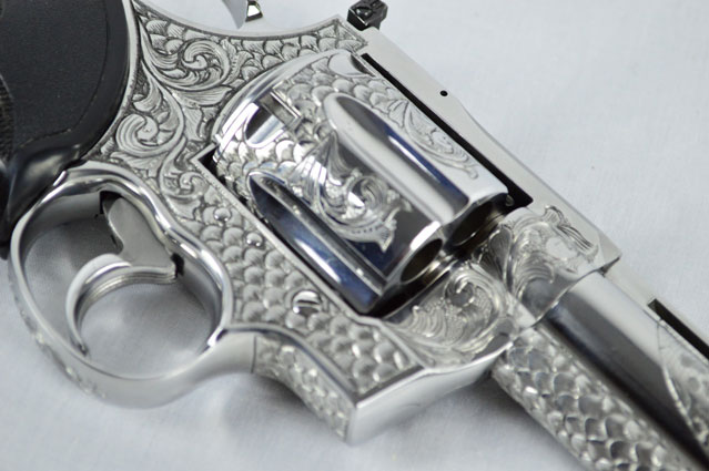 Right Side of Hand Engraved snake scale gun with Anaconda winding down the barrel